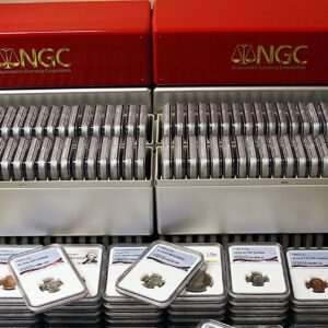 Two boxes filled with graded coins in protective cases.