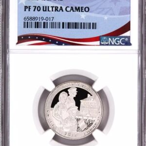 A graded commemorative coin in a protective case.