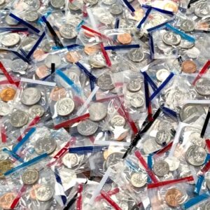 A heap of assorted medals with ribbons in various colors.