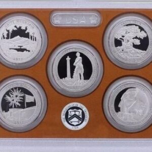 A framed collection of seven commemorative silver coins with various designs.