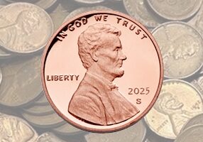 Close-up of a 2025 Lincoln penny with coins in the background.